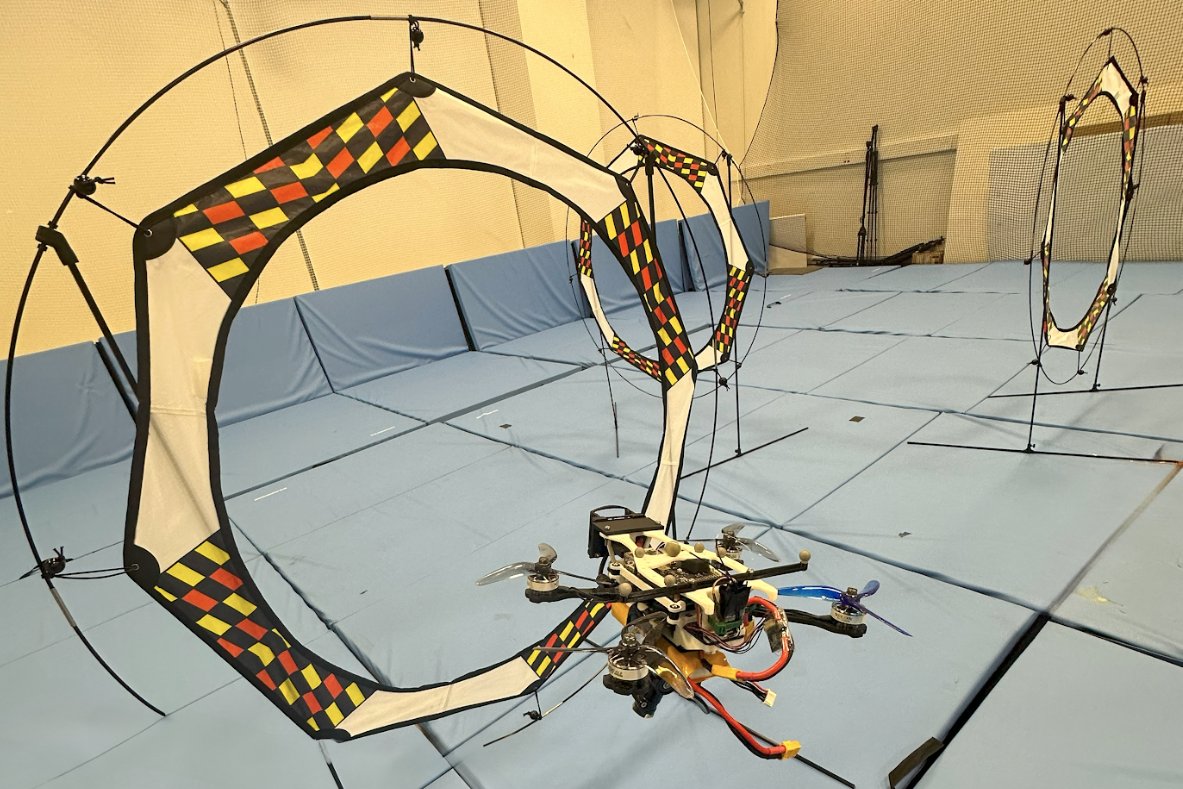 The real flight arena: quadrotor and racing gates used in 30 live hardware flights.
